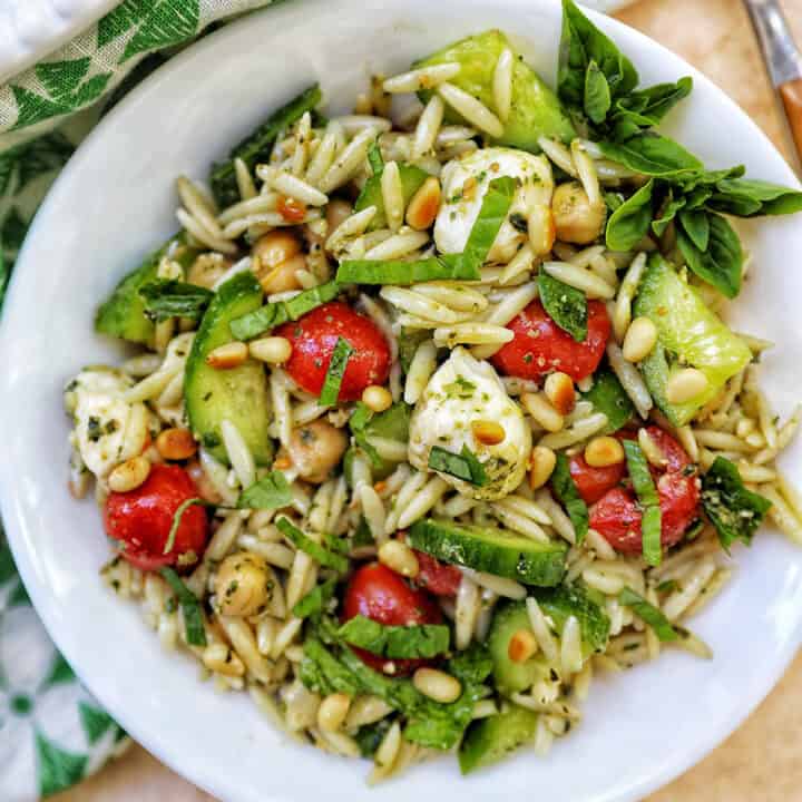 large bowl of orzo pesto pasta salad.