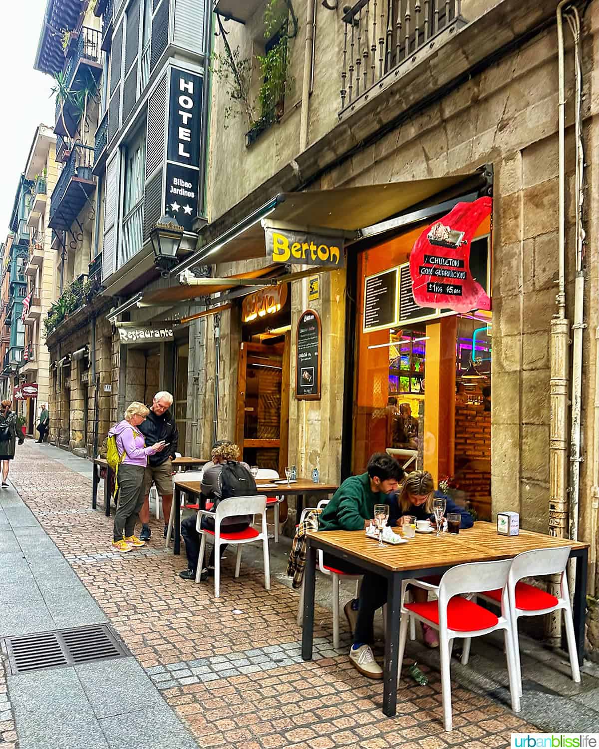 street scene with tables outside of Berton pintxos bar in Bilbao, Spain.