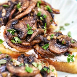 mushroom crostini with fresh thyme garnish.