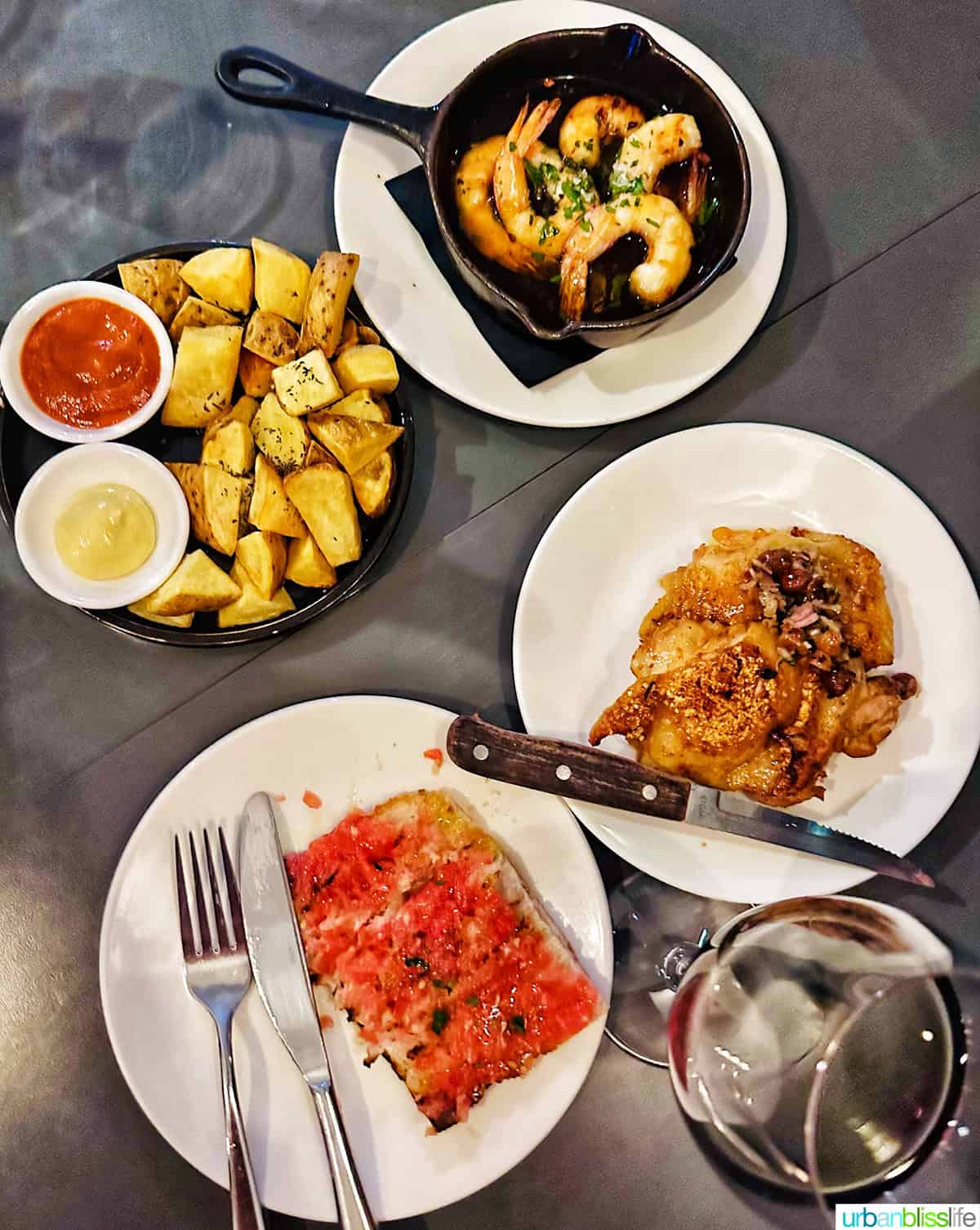 four plates with Spanish tapas on a table Brindisa in London..