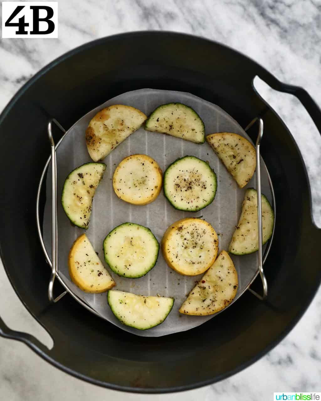 air fried zucchini and yellow squash in an air fryer basket.