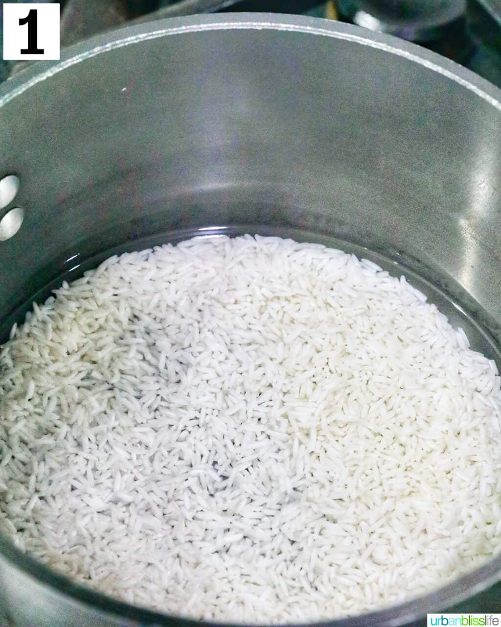 rice cooking in water in a pan.