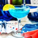 blue wave cocktail with red, white, and blue decorations in the background.