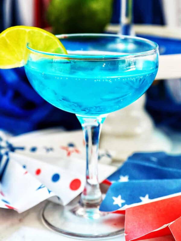blue wave cocktail with red, white, and blue decorations in the background.