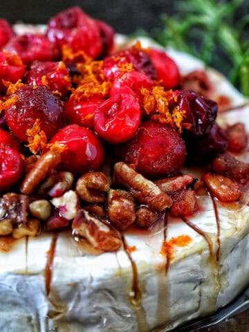 cranberry pecan baked brie in a skillet.