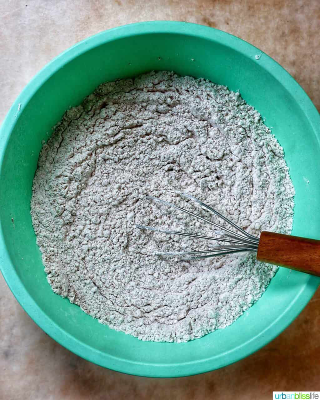 dry ingredients to make pumpkin spice cookies in a green bowl.