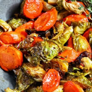 roasted brussels sprouts and carrot slices in a bowl.