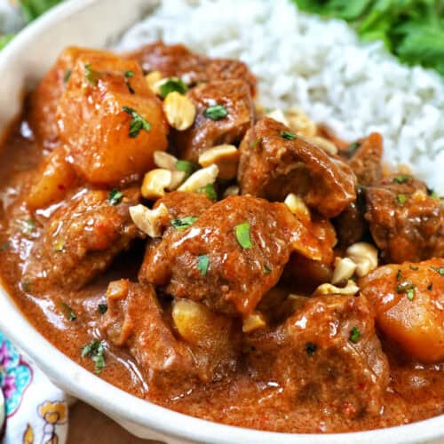 slow cooker beef massaman curry with rice in a bowl.