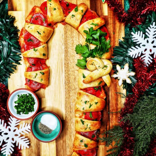 candy cane pizza surrounded by holiday decorations.