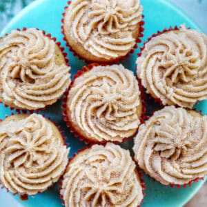 cinnamon cupcakes on a blue cake pedestal.