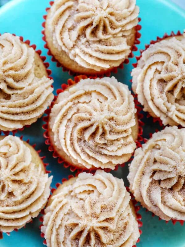 cinnamon cupcakes on a blue cake pedestal.