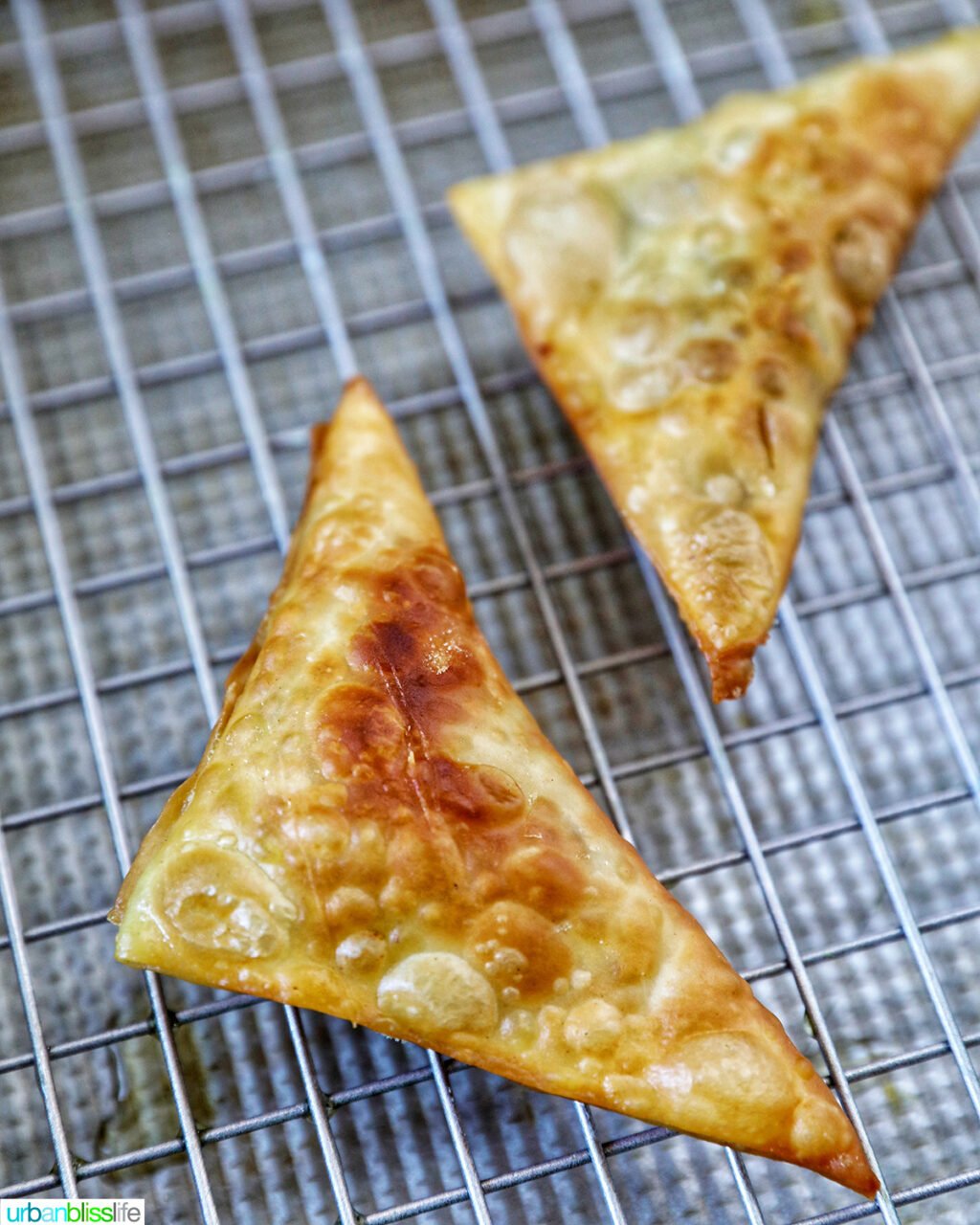 vegan curry samosas frying in a dutch oven.