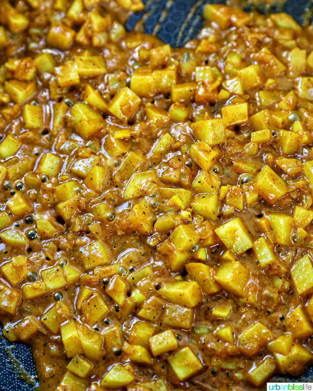 diced potatoes cooking in curry spices.