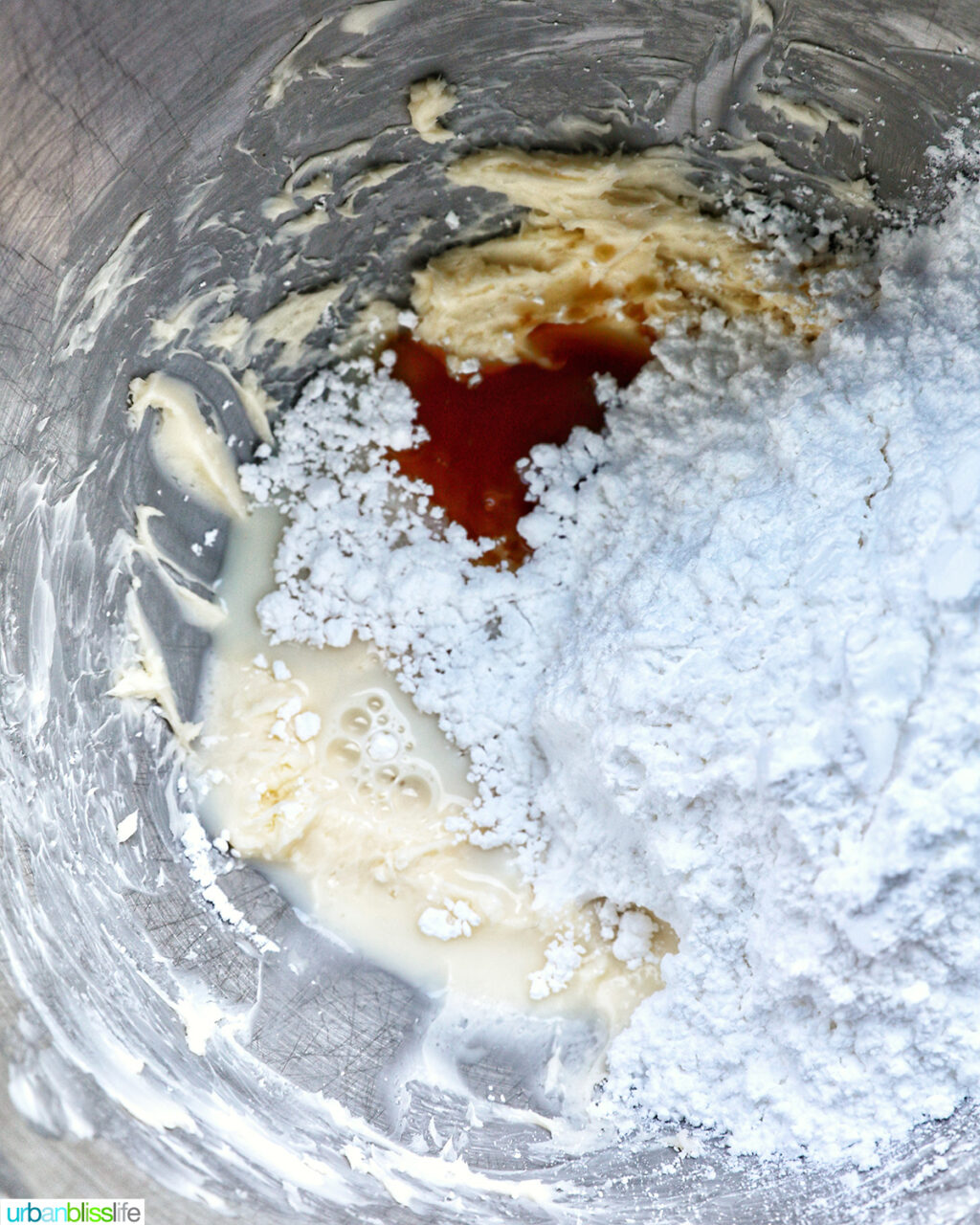 ingredients to make buttercream frosting in a stand mixing bowl.