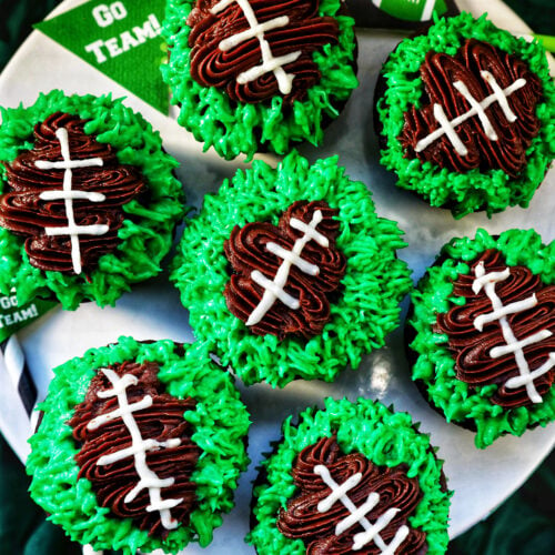 football cupcakes decorated on a cake stand