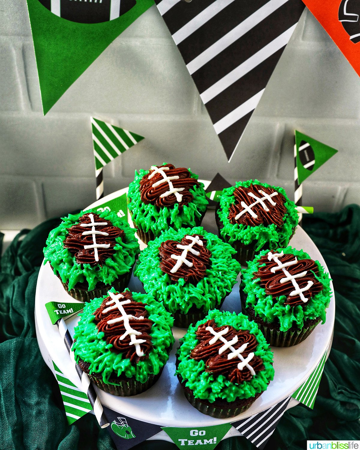 football cupcakes decorated on a cake stand.