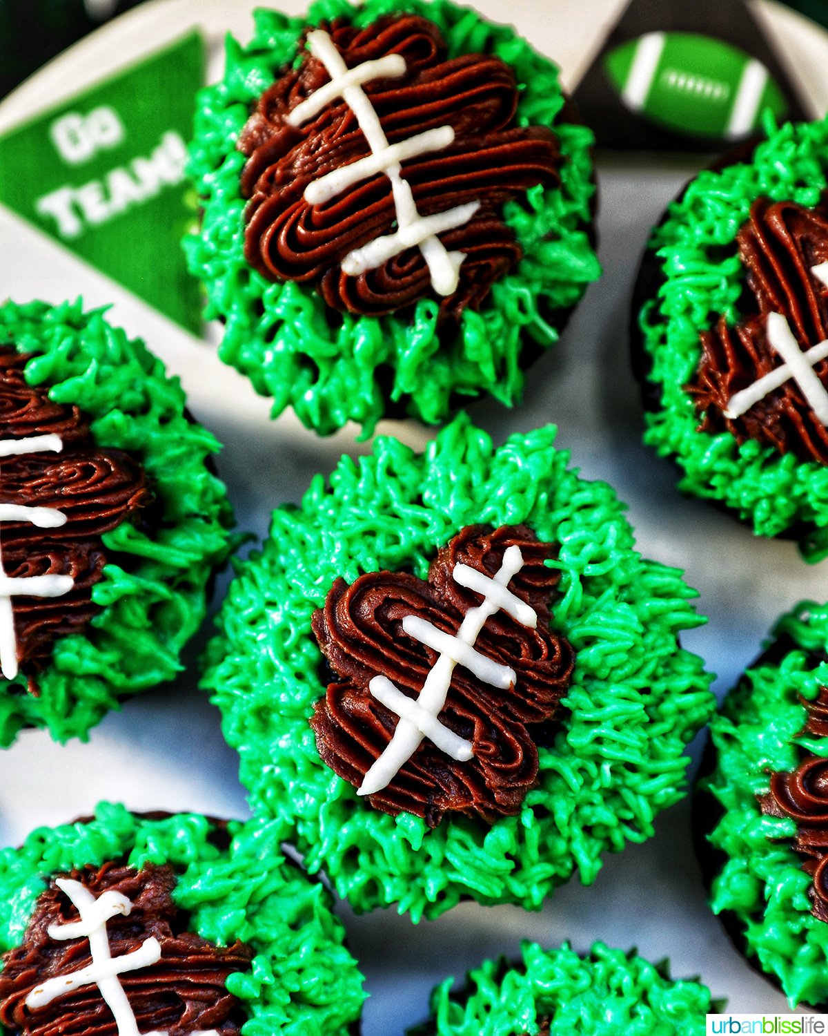 football cupcakes decorated on a cake stand.