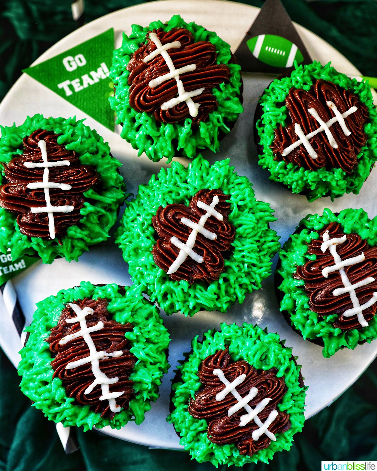 football cupcakes decorated on a cake stand.