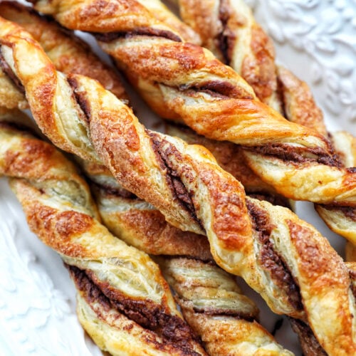 puff pastry chocolate twists on a white serving tray.