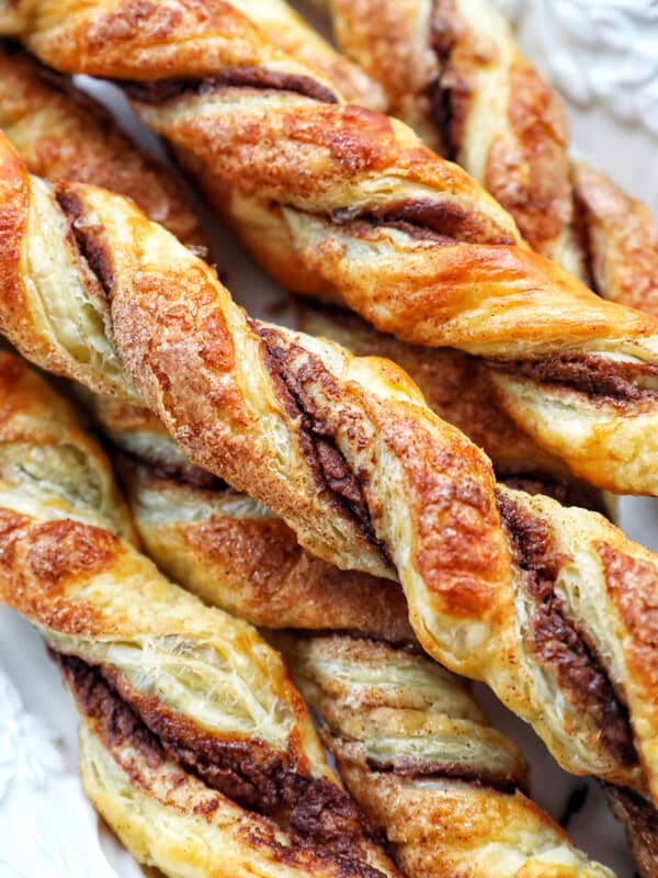 puff pastry chocolate twists on a white serving tray.