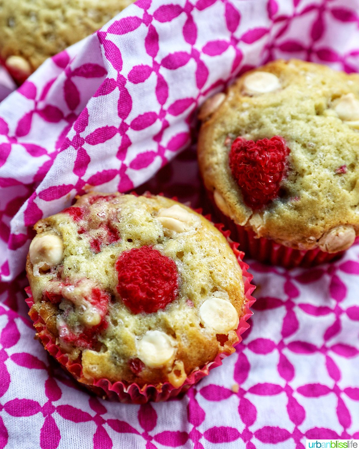 two raspberry white chocolate chip muffins.