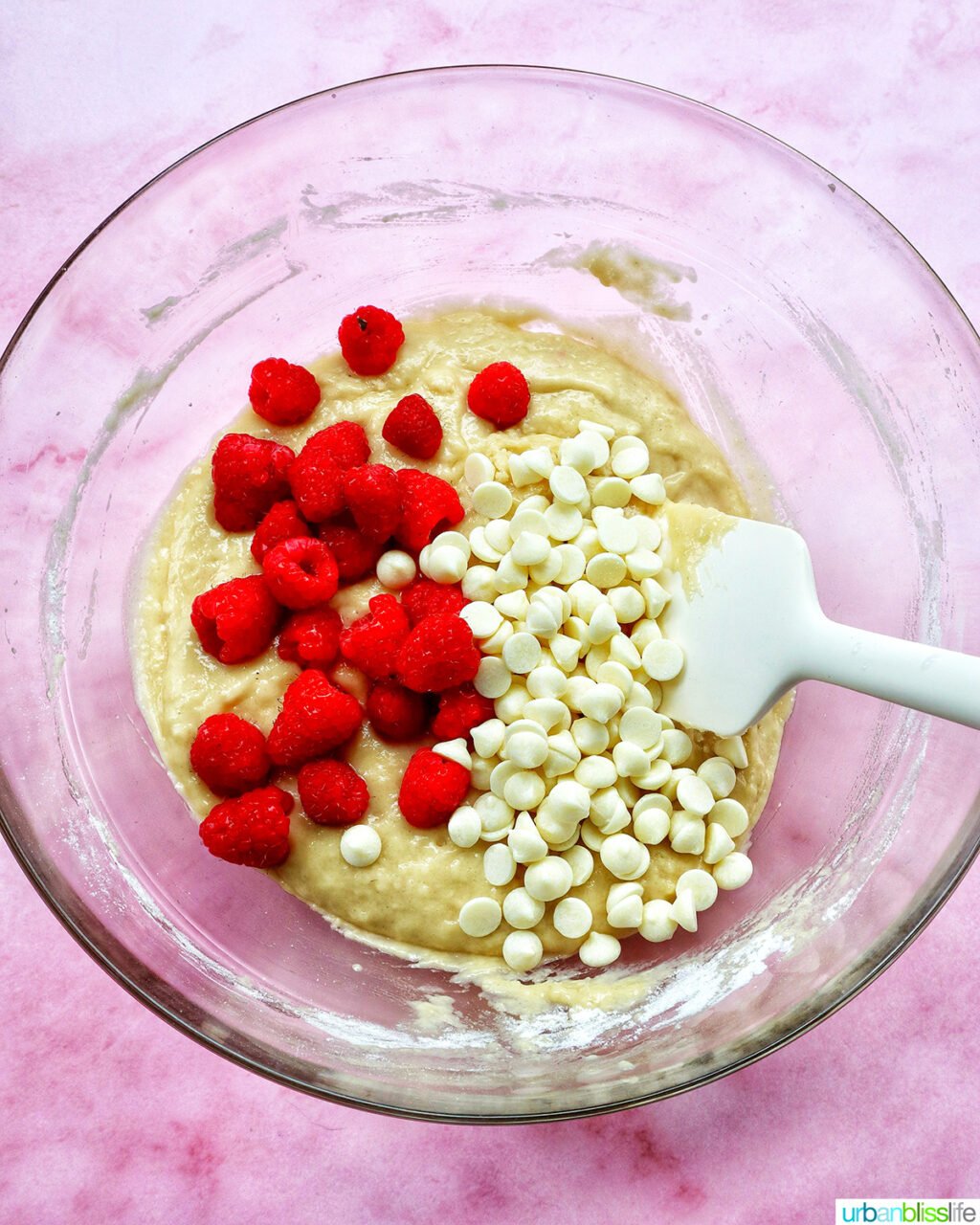 raspberries and white chocolate chips in a bowl.