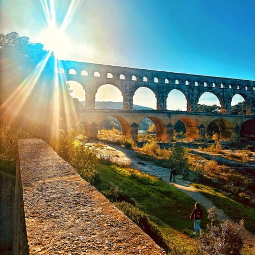 pont du gard with sunburst.