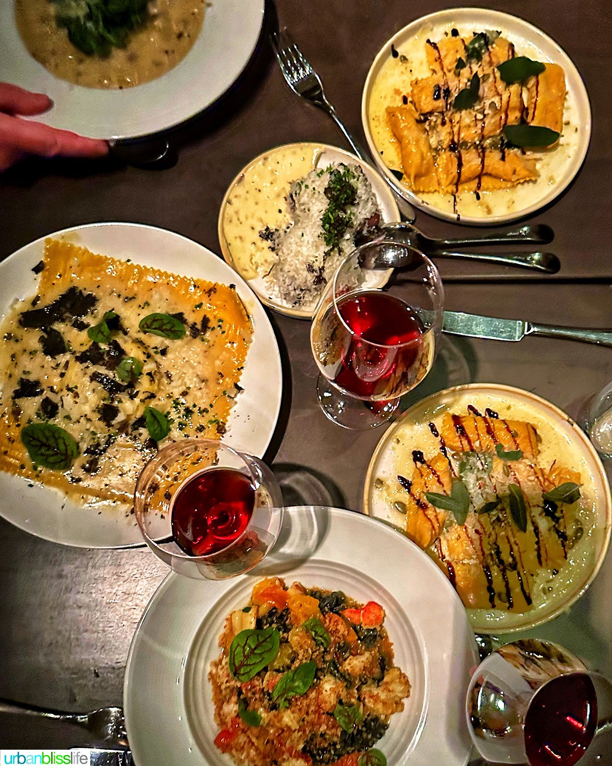 overhead photo of Italian food and red wine at Carlotto restaurant in NYC New York.