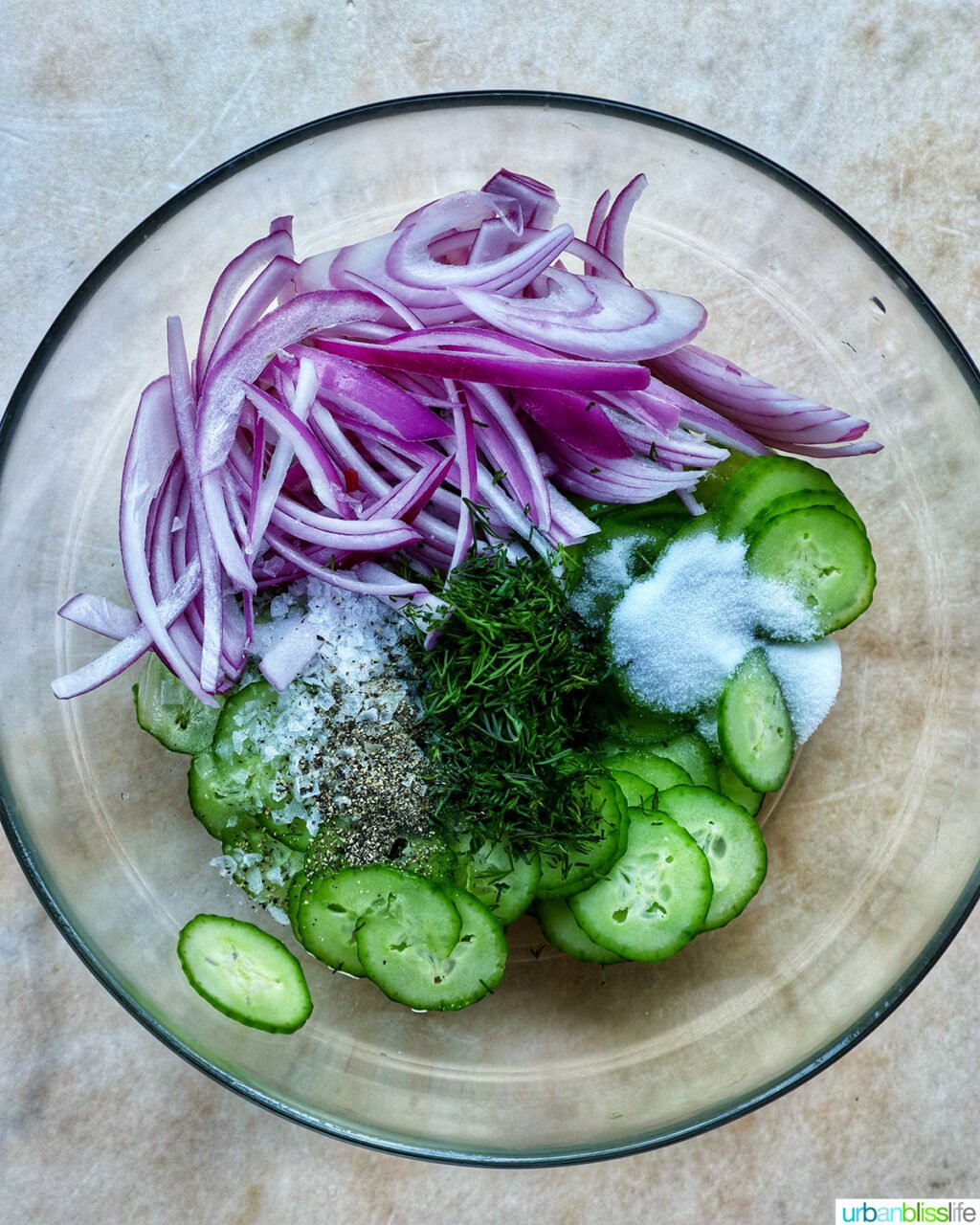 bowl of ingredients for cucumber dill salad.