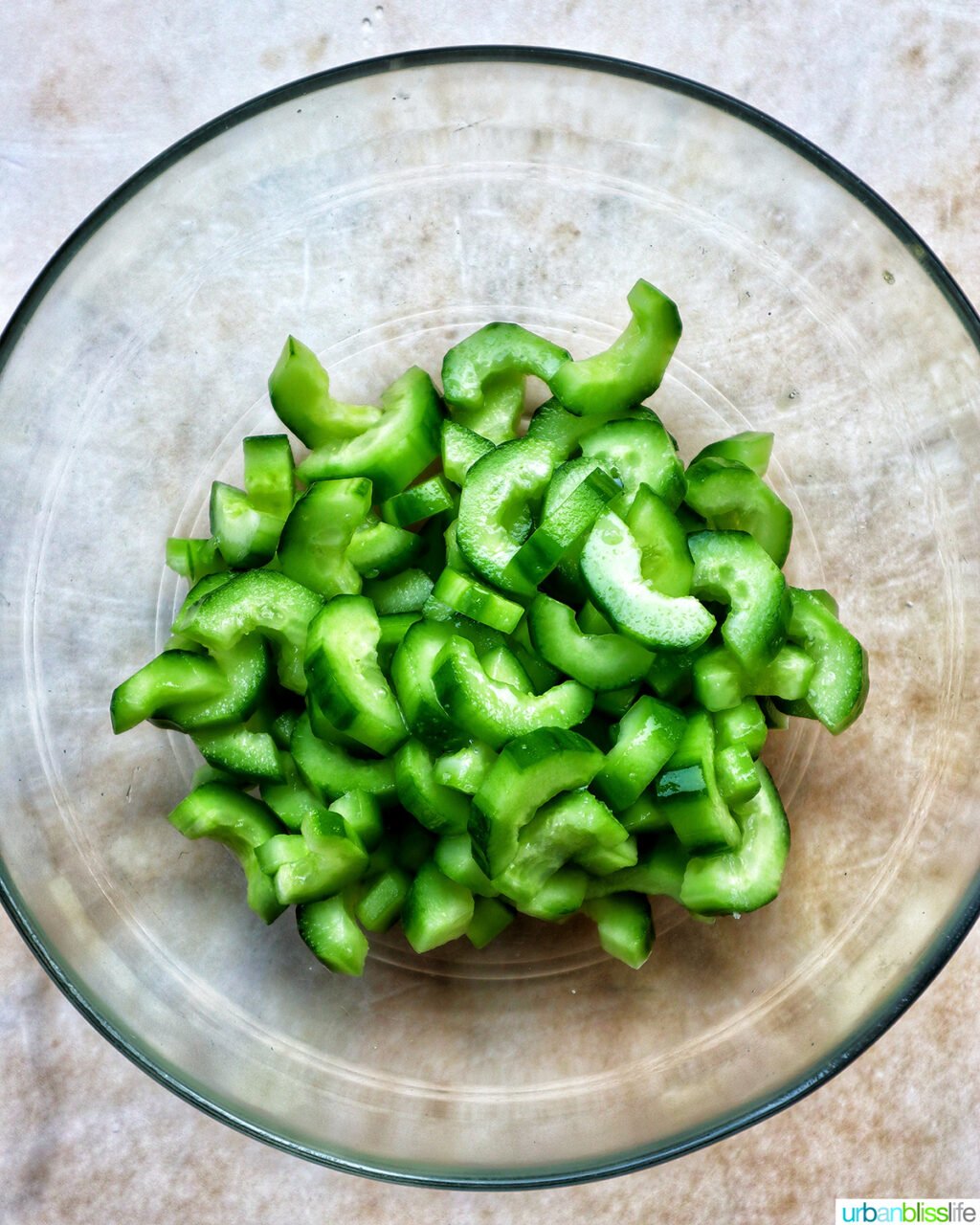 bowl of cucumbers sliced into half moons.