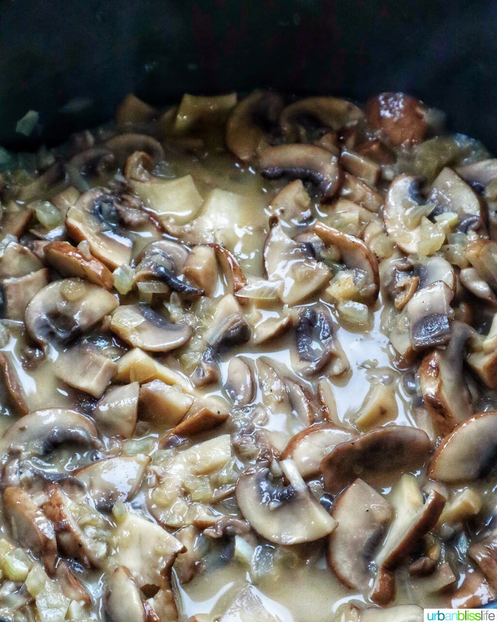 mushrooms in liquid in a pot.