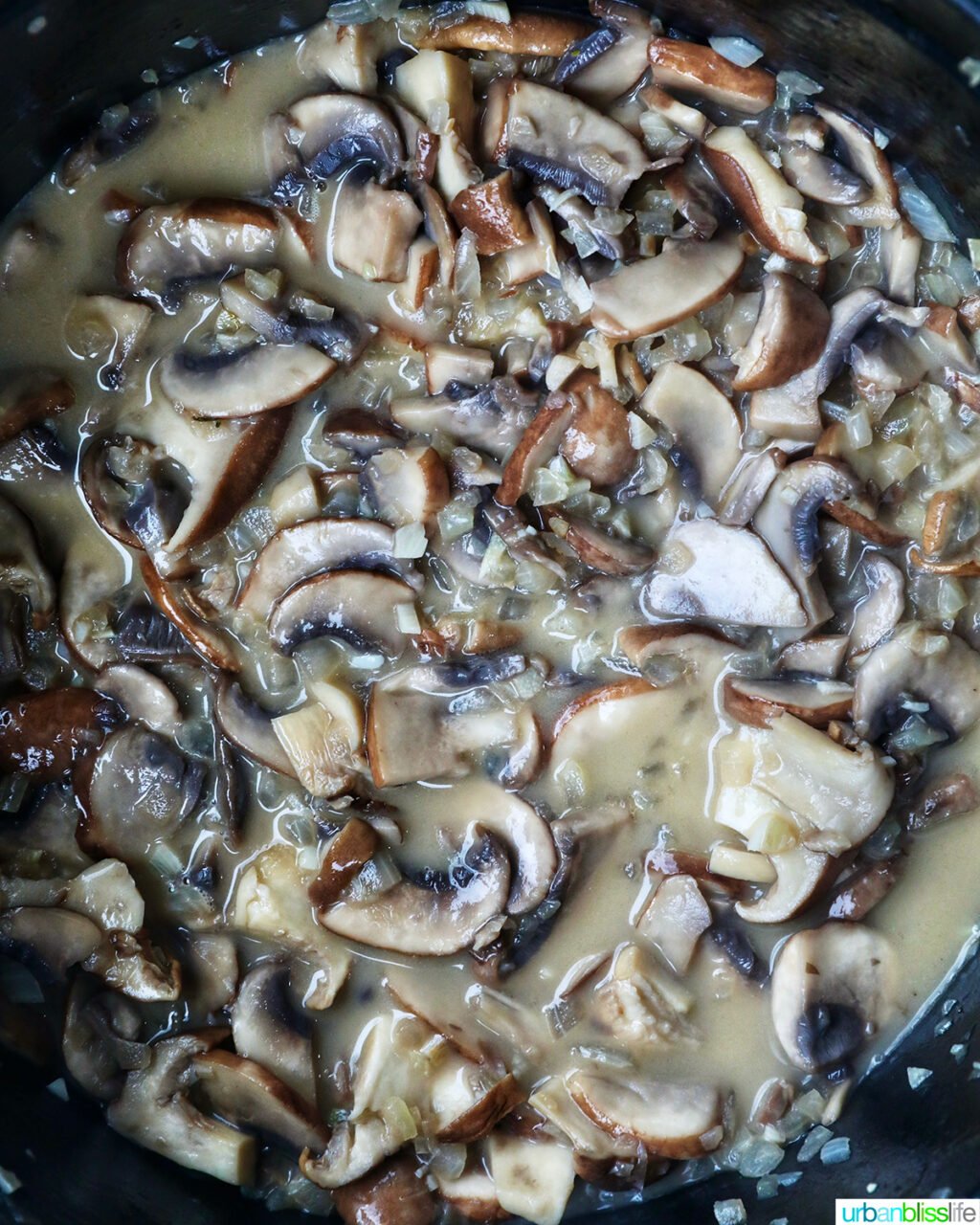 mushrooms in broth in a pot.