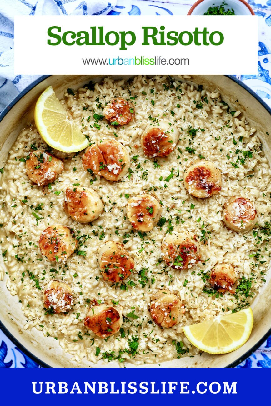 braising pan with scallop risotto with lemon wedge and parsley garnish.