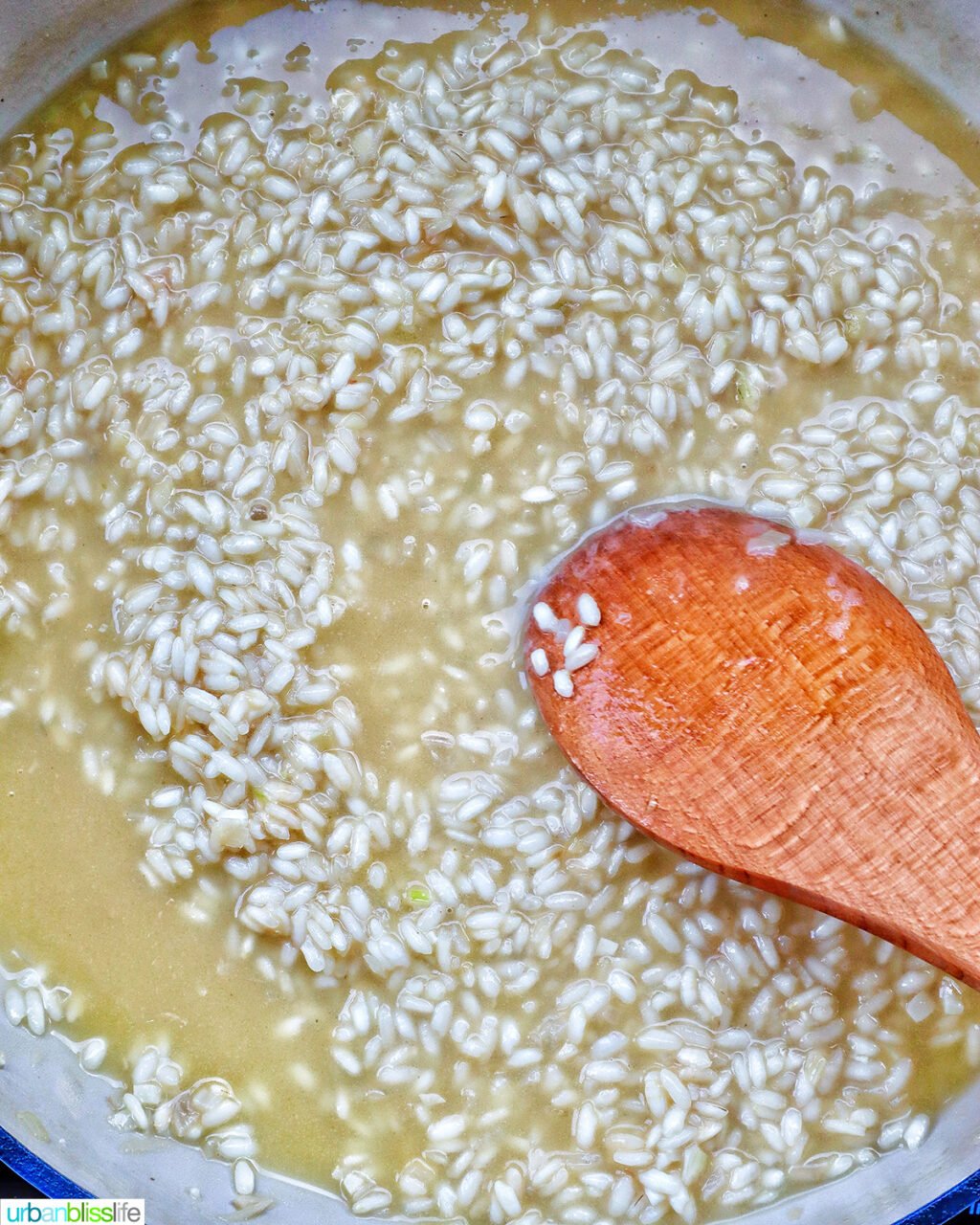 wooden spoon stirring risotto.