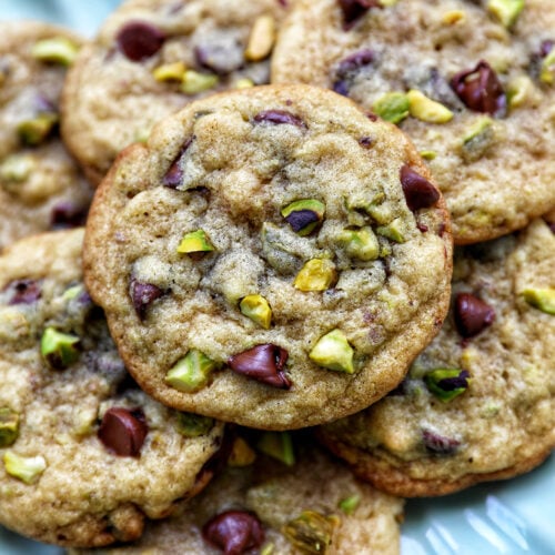 chocolate chip pistachio cookies on a plate.