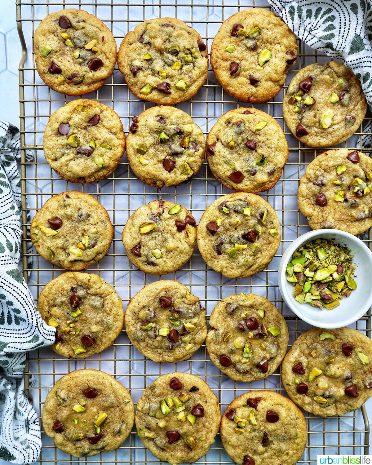rows of chocolate chip pistachio cookies on a cooling rack.