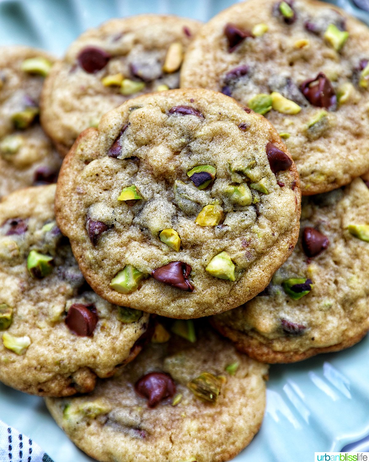 chocolate chip pistachio cookies on a plate.