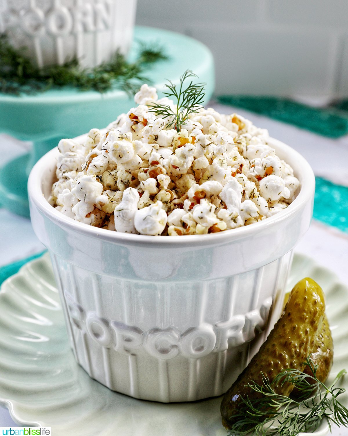dill pickle popcorn in a white bowl.