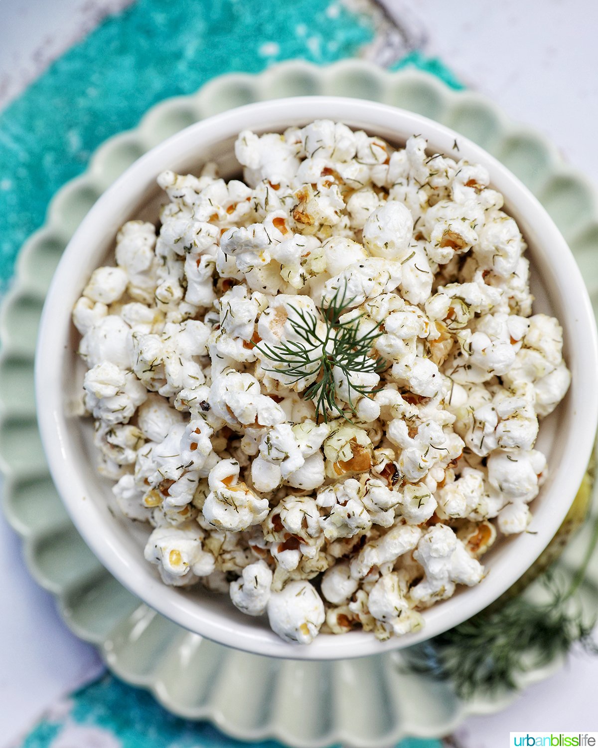 dill pickle popcorn in a white bowl.
