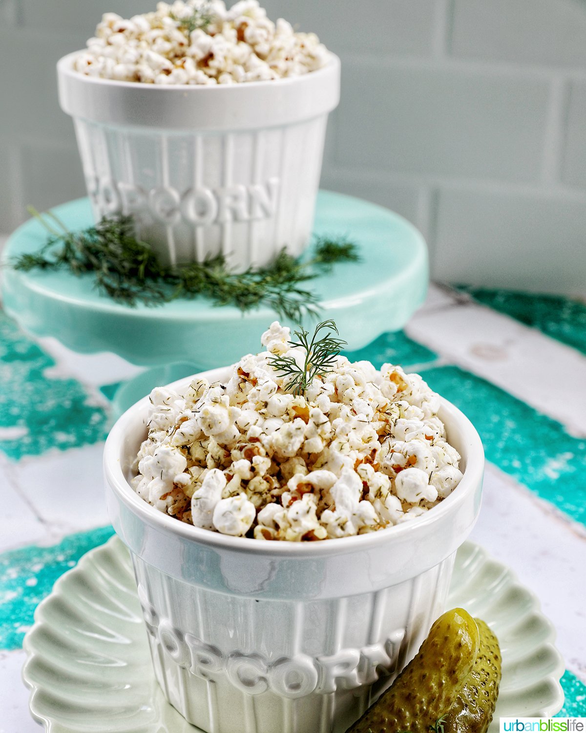 two bowls of dill pickle popcorn.