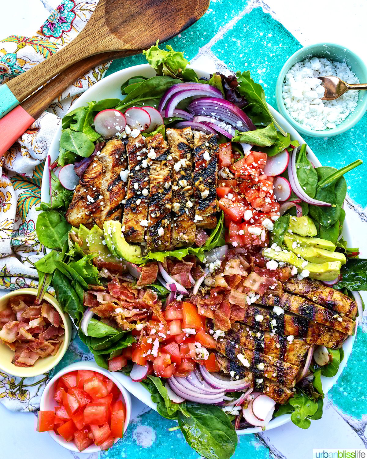 Balsamic Chicken Salad with bowls of tomatoes, bacon, feta cheese.