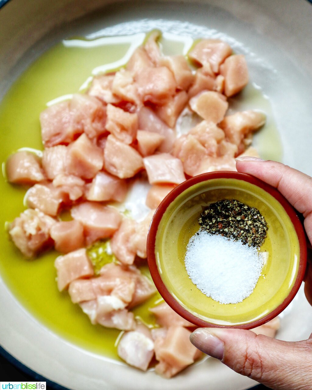 cubed chicken cooking in a pan.