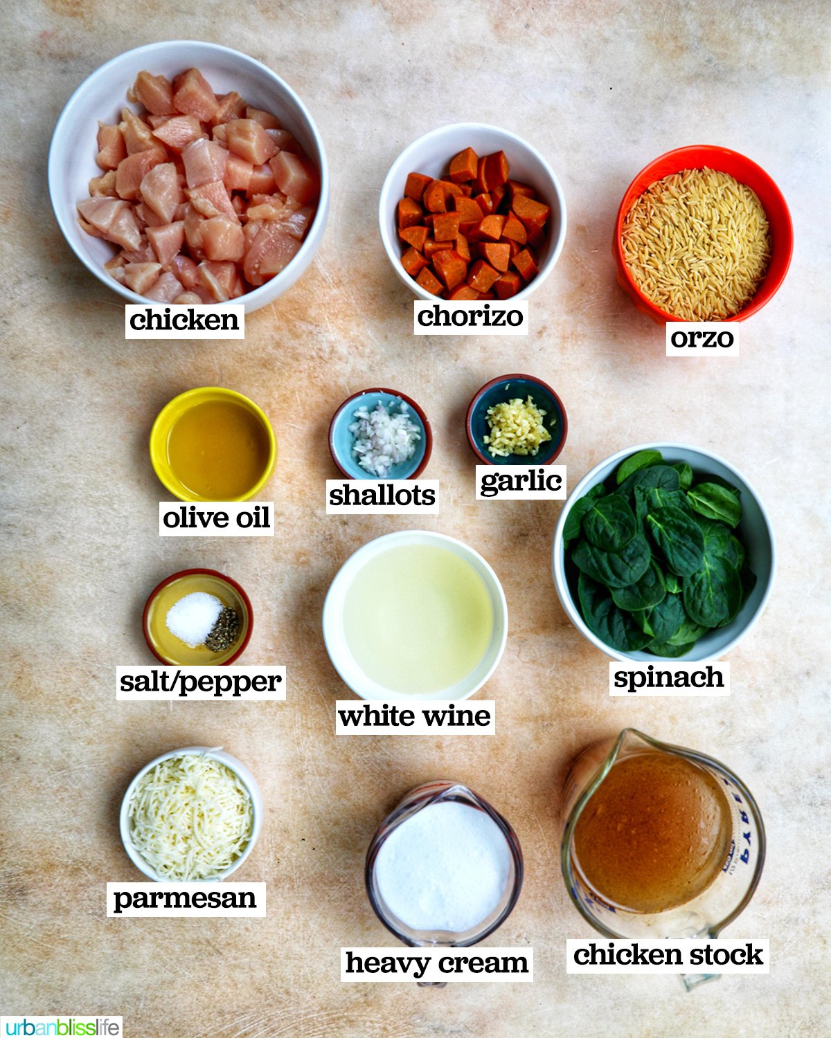 bowls of ingredients to make wooden spoonful of chicken and chorizo orzo.
