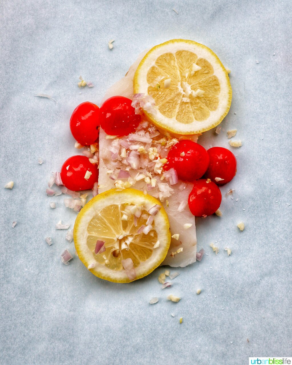 cod white fish covered in tomatoes, shallots, garlic, and lemons.