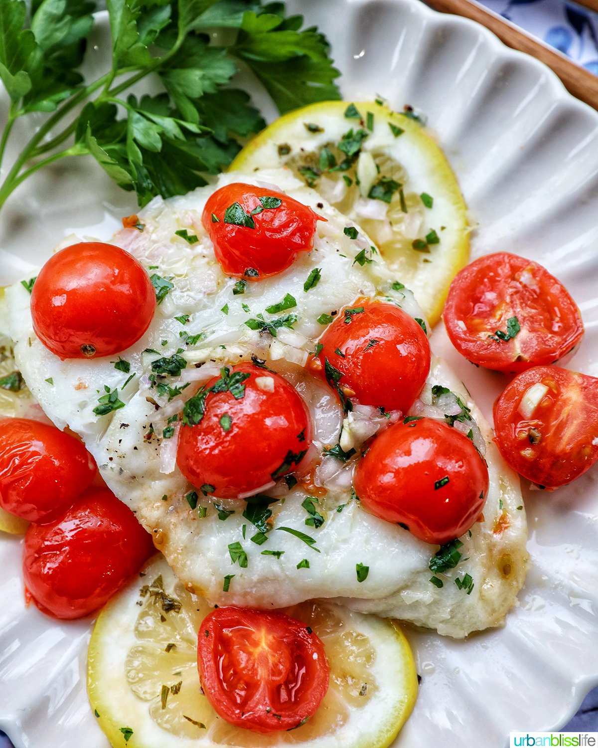 Cod en Papillote on a plate with fresh herbs.