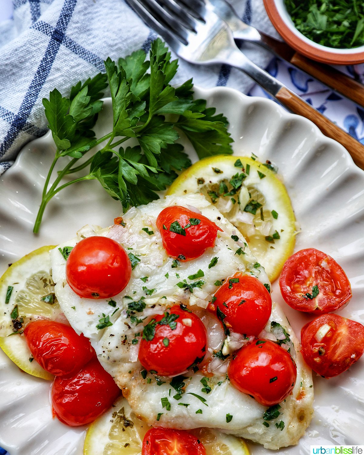 Cod en Papillote on a plate with fresh herbs.