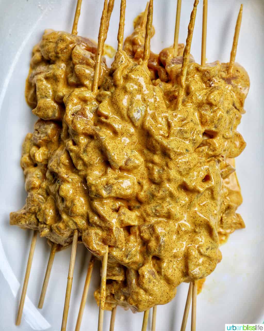 plate of marinated bang bang chicken skewers