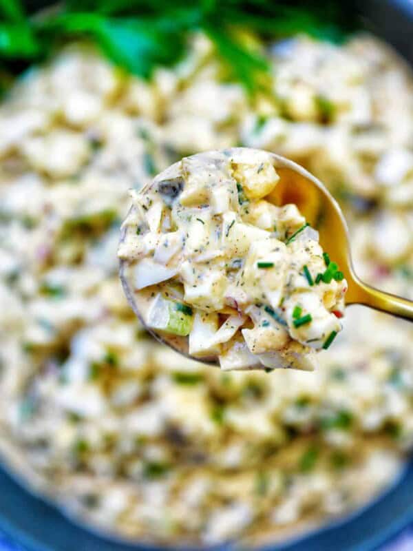 spoonful of egg salad over a bowl of dill pickle egg salad.