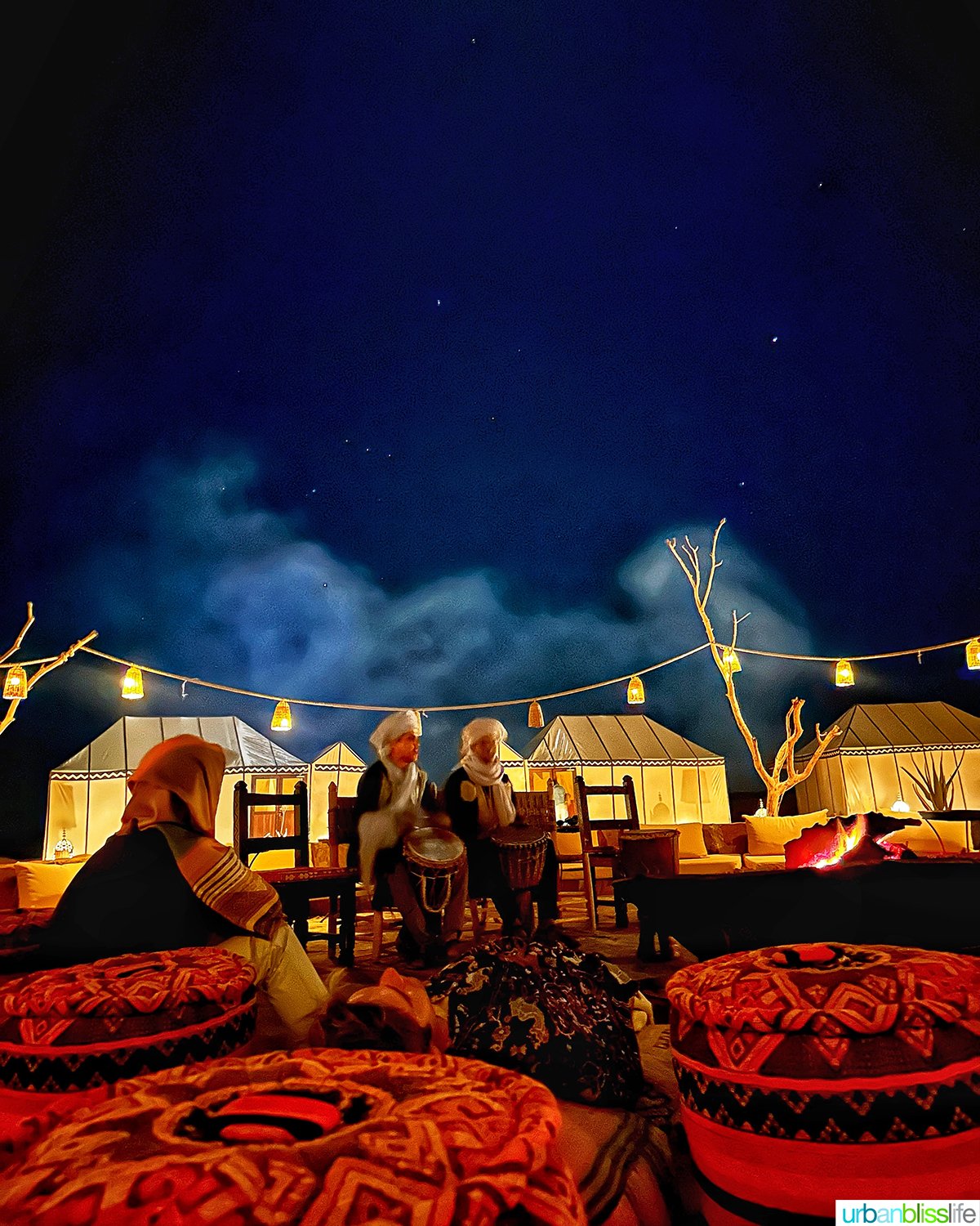 musicians around fire at a luxury desert camp in the sahara desert in Morocco.