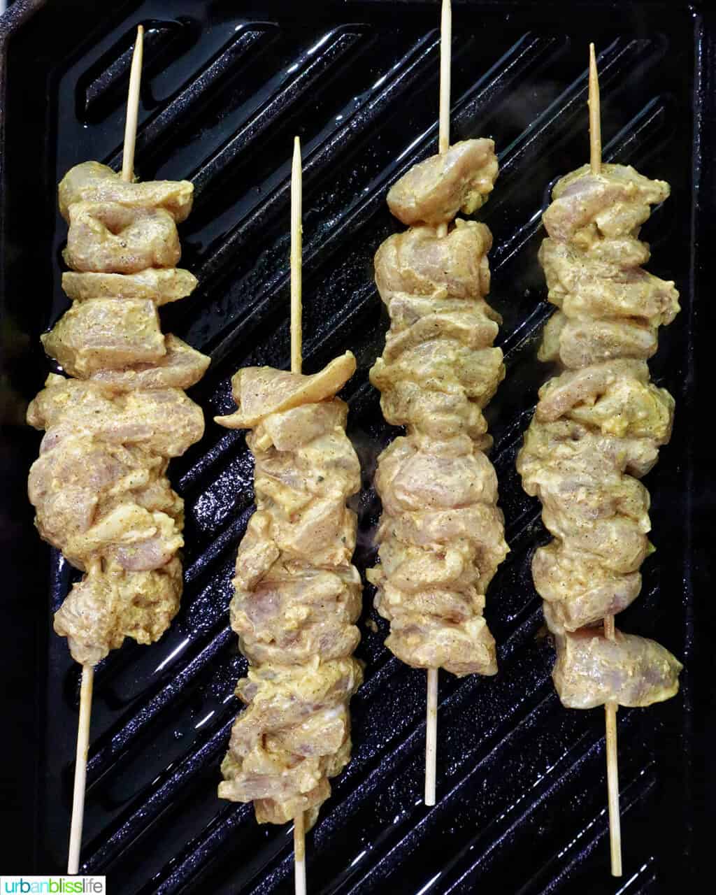 tandoori chicken skewers on a grill pan.